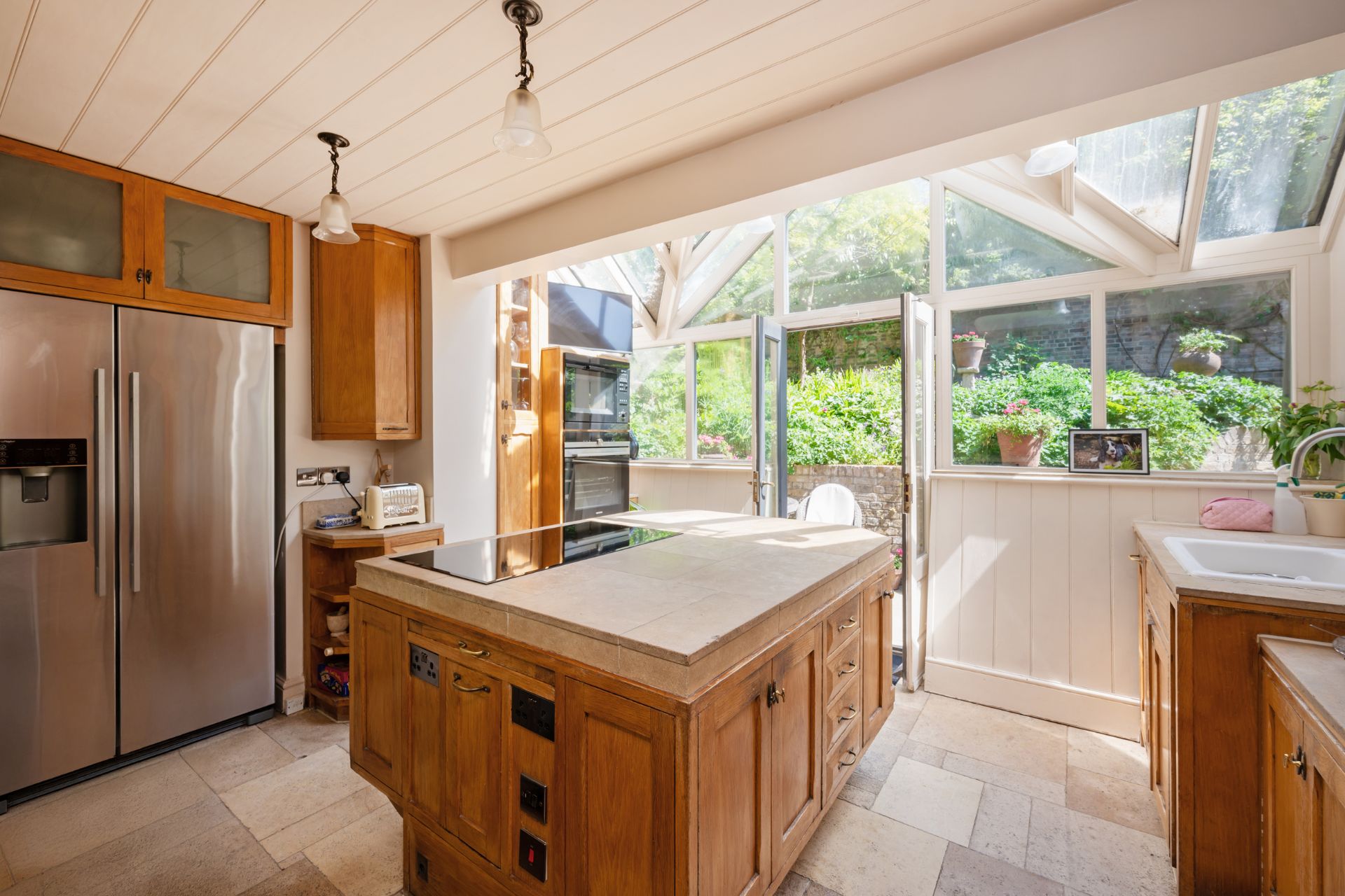 Kitchen with oal cabinets, white tile floors and white marble worktops