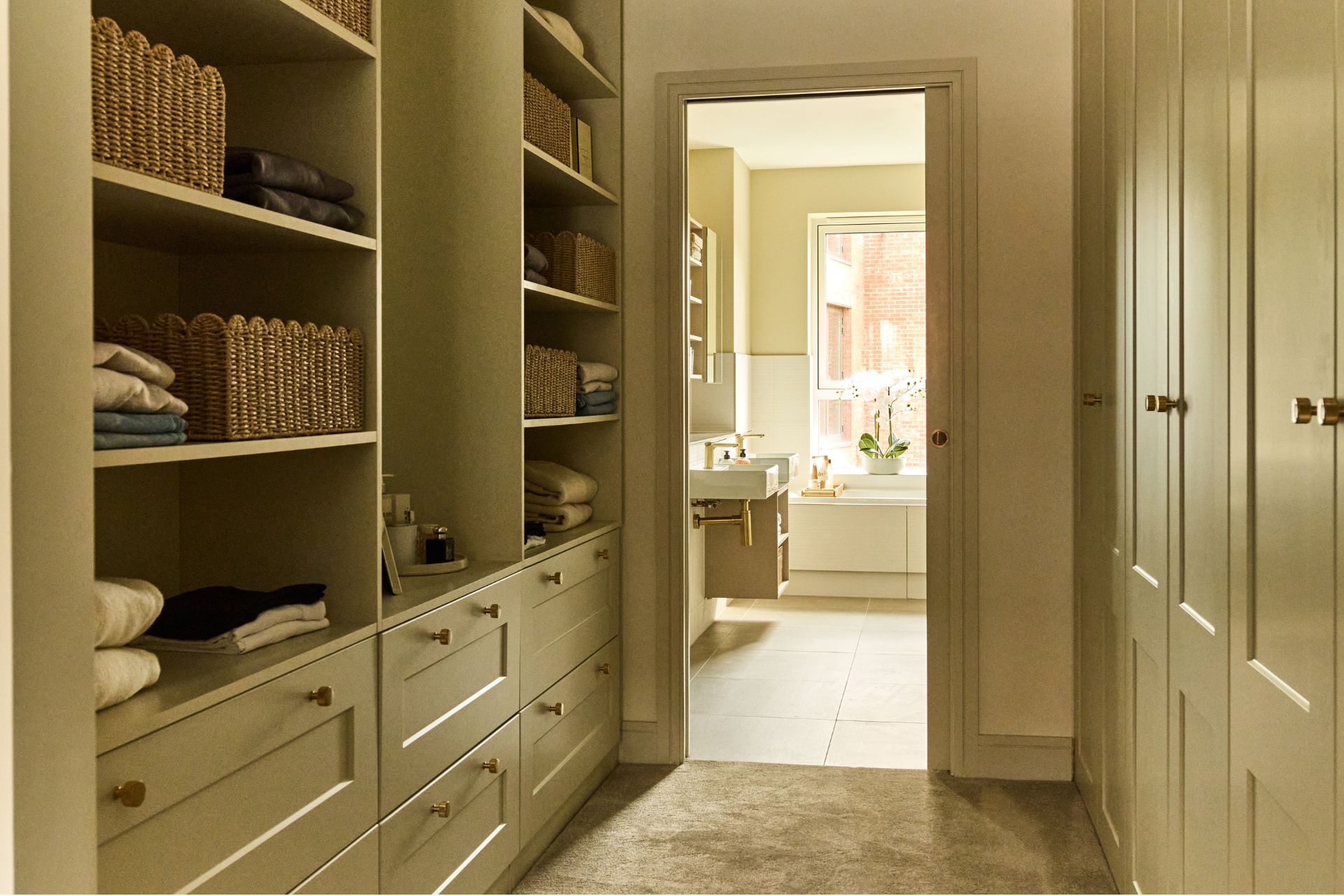 Pale green dressing room with Shaker cabinets