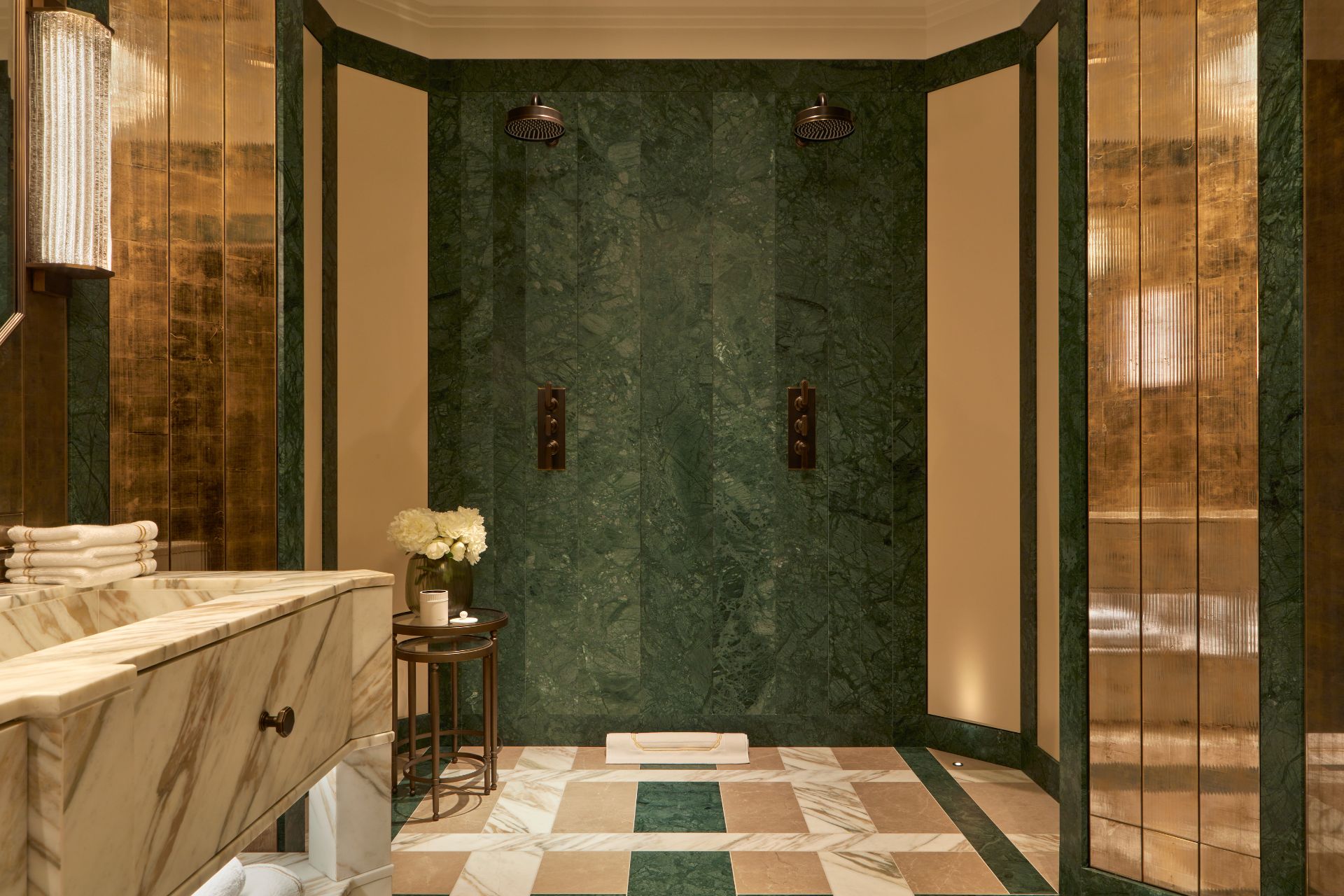 Bathroom with veined white marble vanity unit and green marble backsplash