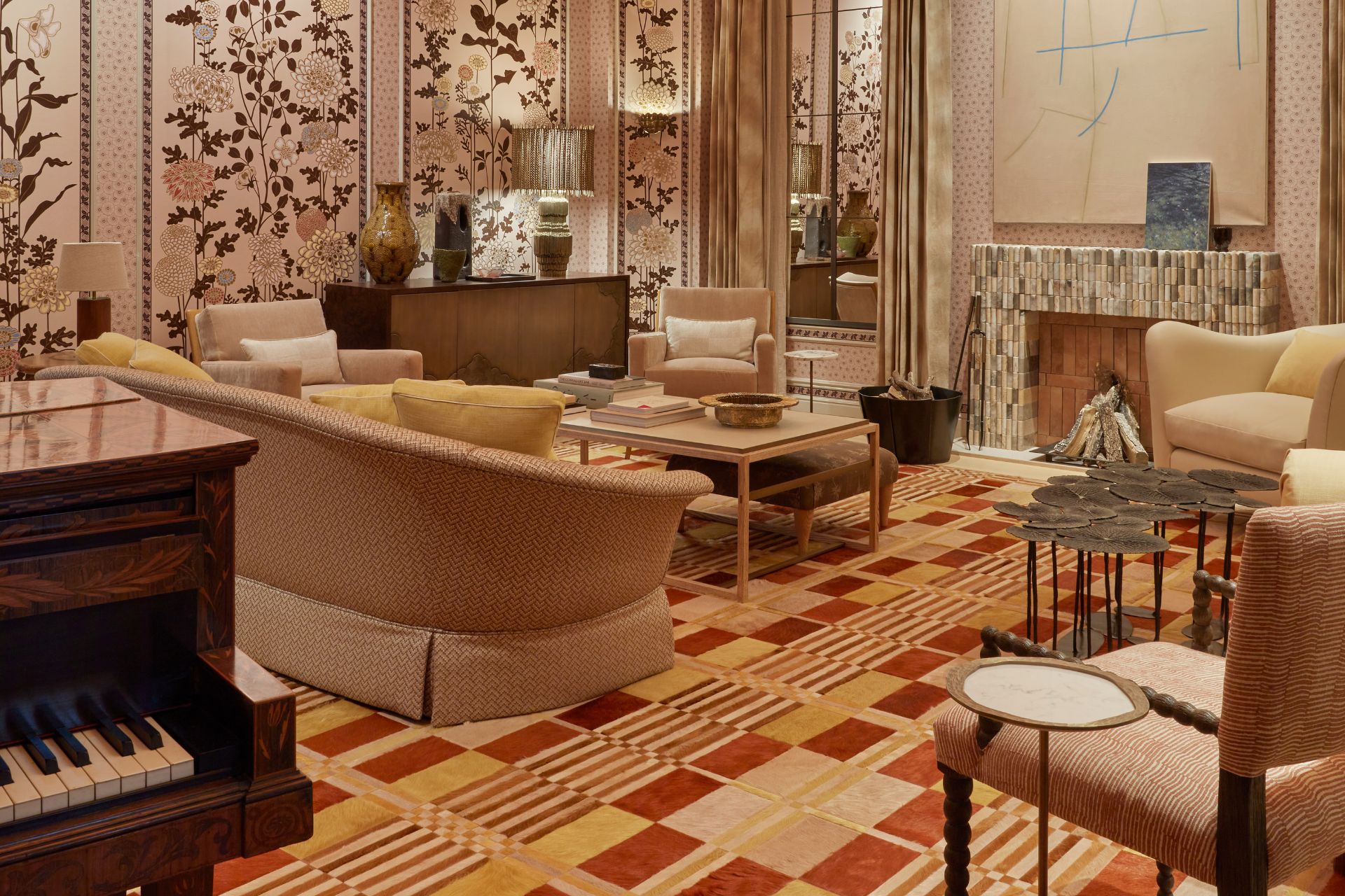 Drawing room with red and yellow colourblock carpet, taupe sofas and pale pink floral wallcoverings