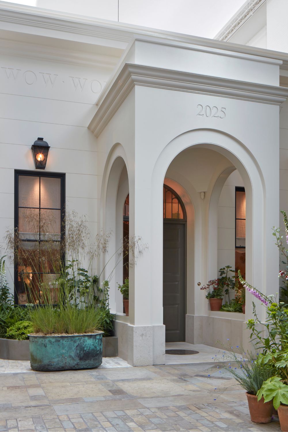 White Georgian-style facadw with 'Wow House 2025' inscribed above the central archway