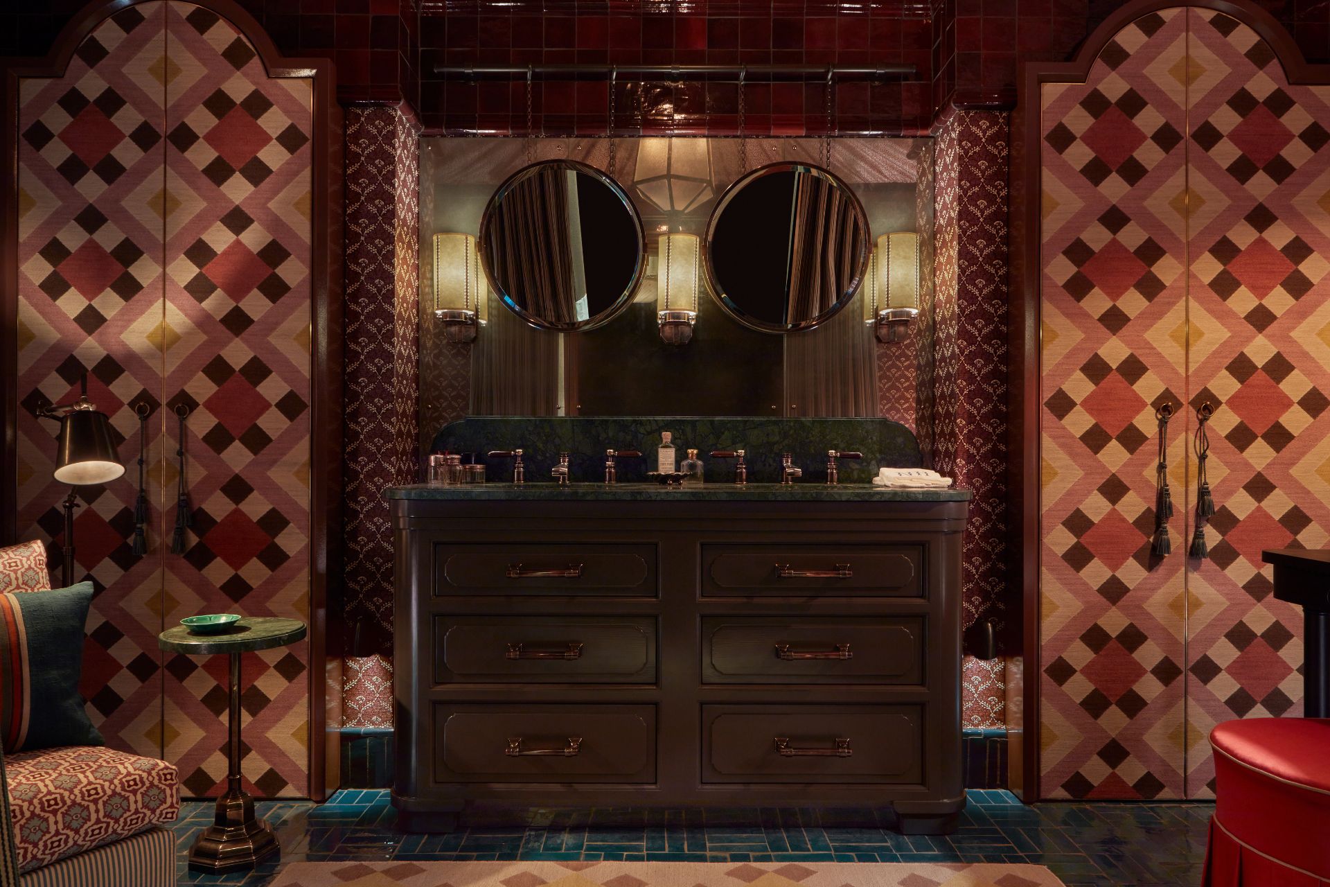 Powder room with deep purple ccents, two round mirrors, and a dark wooden double vanity unit