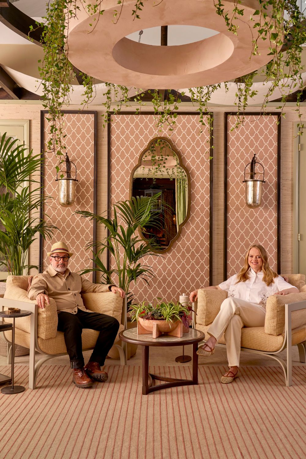 Courtyard with pink and white trellis wallcoverings and ivy garlands