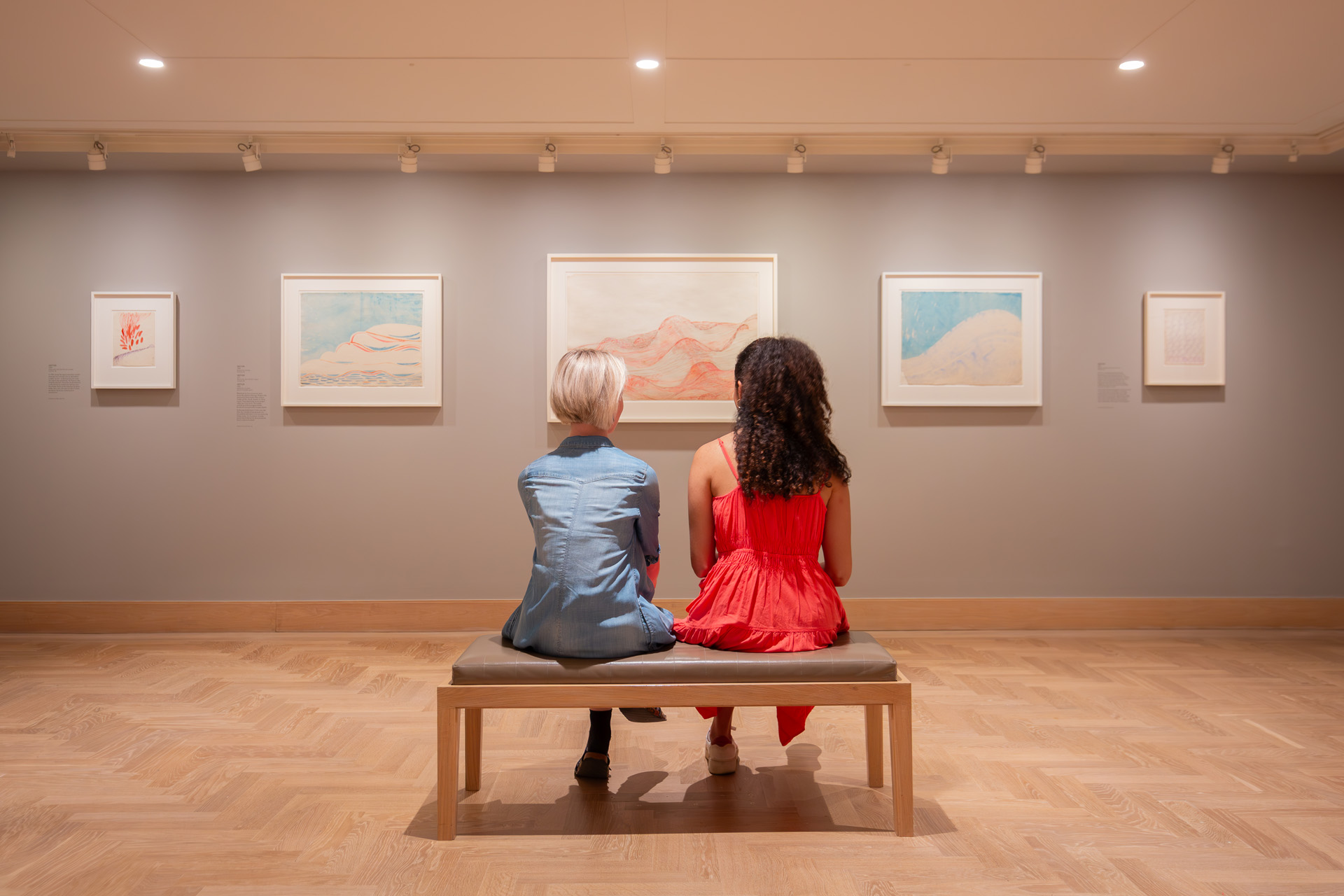 Two women looking at paintings at the Courtauld