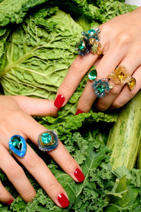 Close up of hands on cabbage wearing rings