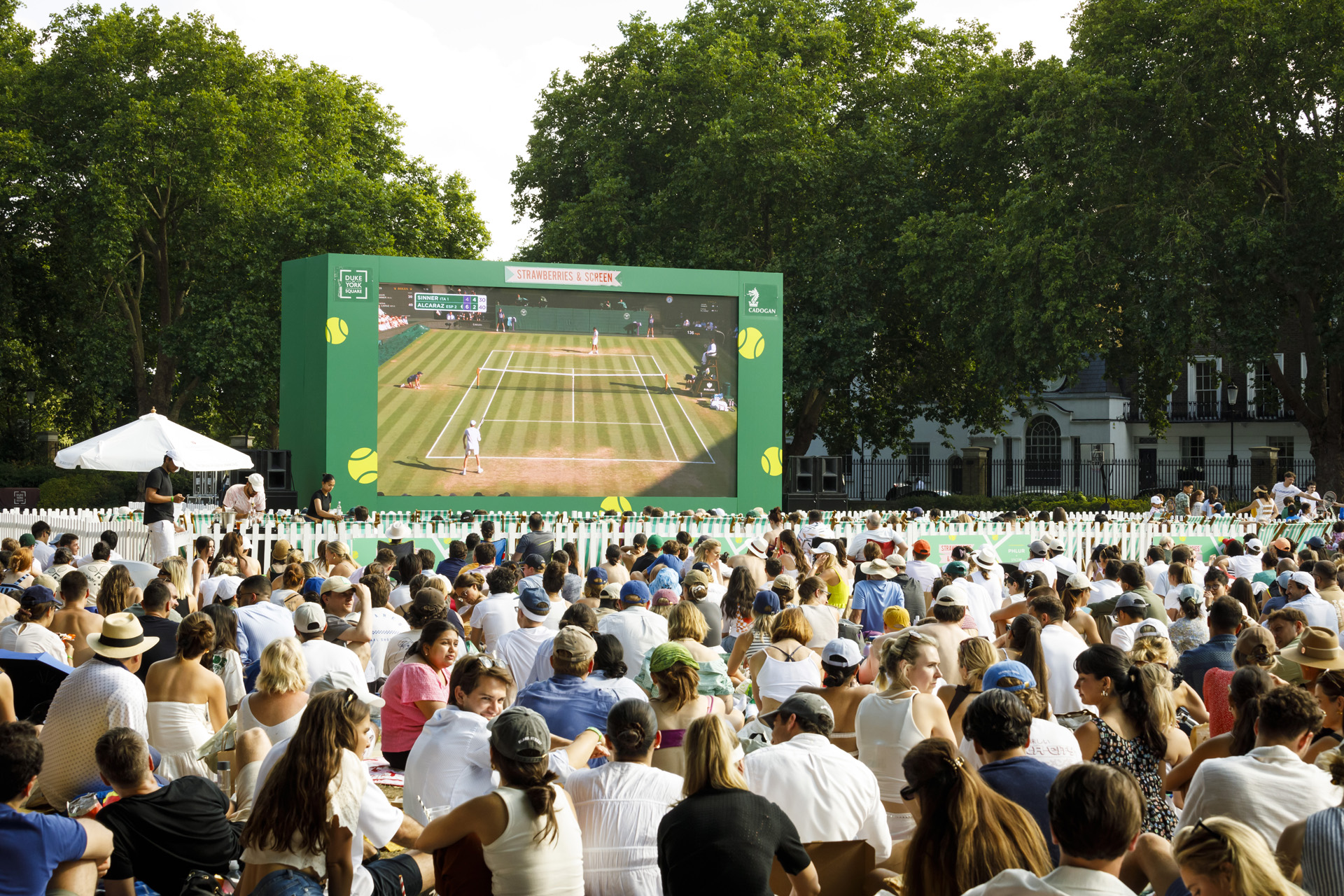 Tennis fans watching Wimbledon outside in Chelsea in 2025