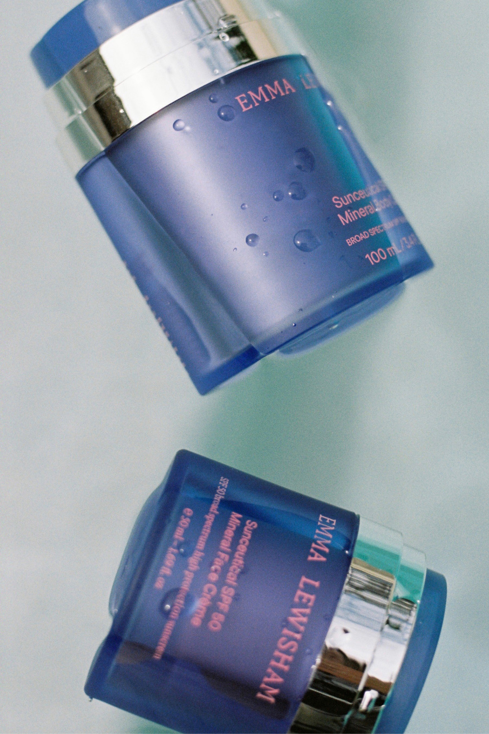 Blue tubs of face cream and serum
