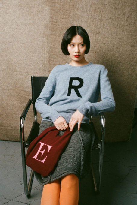 Woman holding alphabet bag
