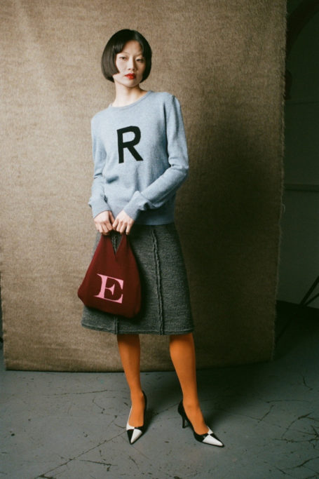 Woman holding alphabet bag
