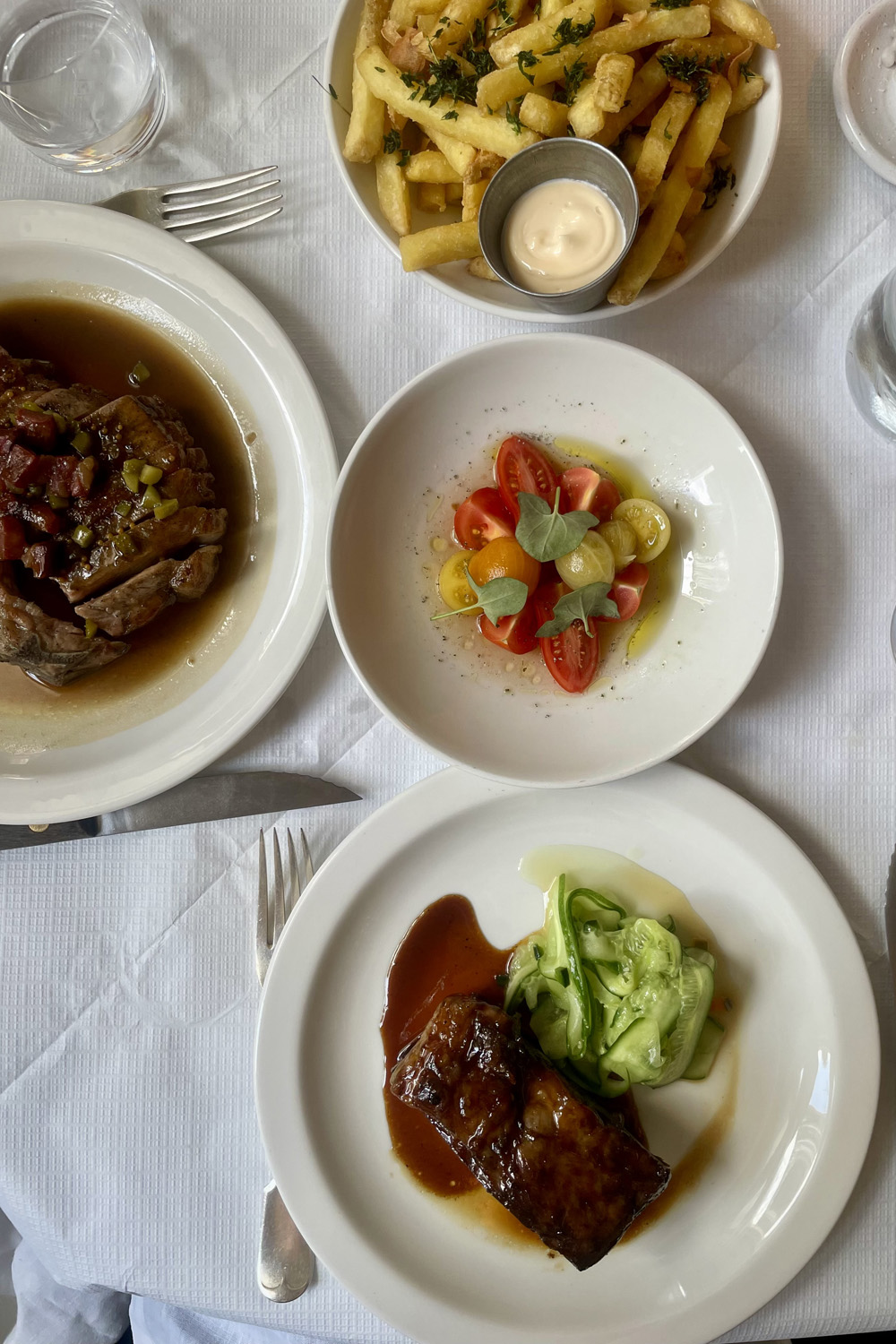 A selection of dishes at The Hero: Pork, fries, tomatoes, short rib