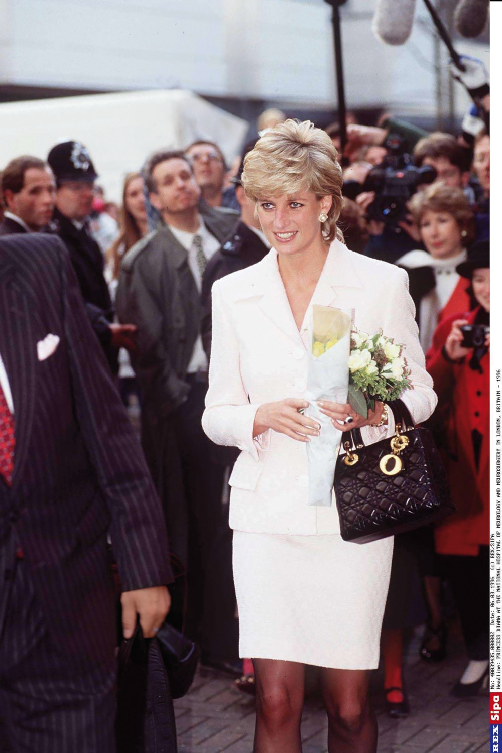 Woman holding Lady Dior bag in Paris
