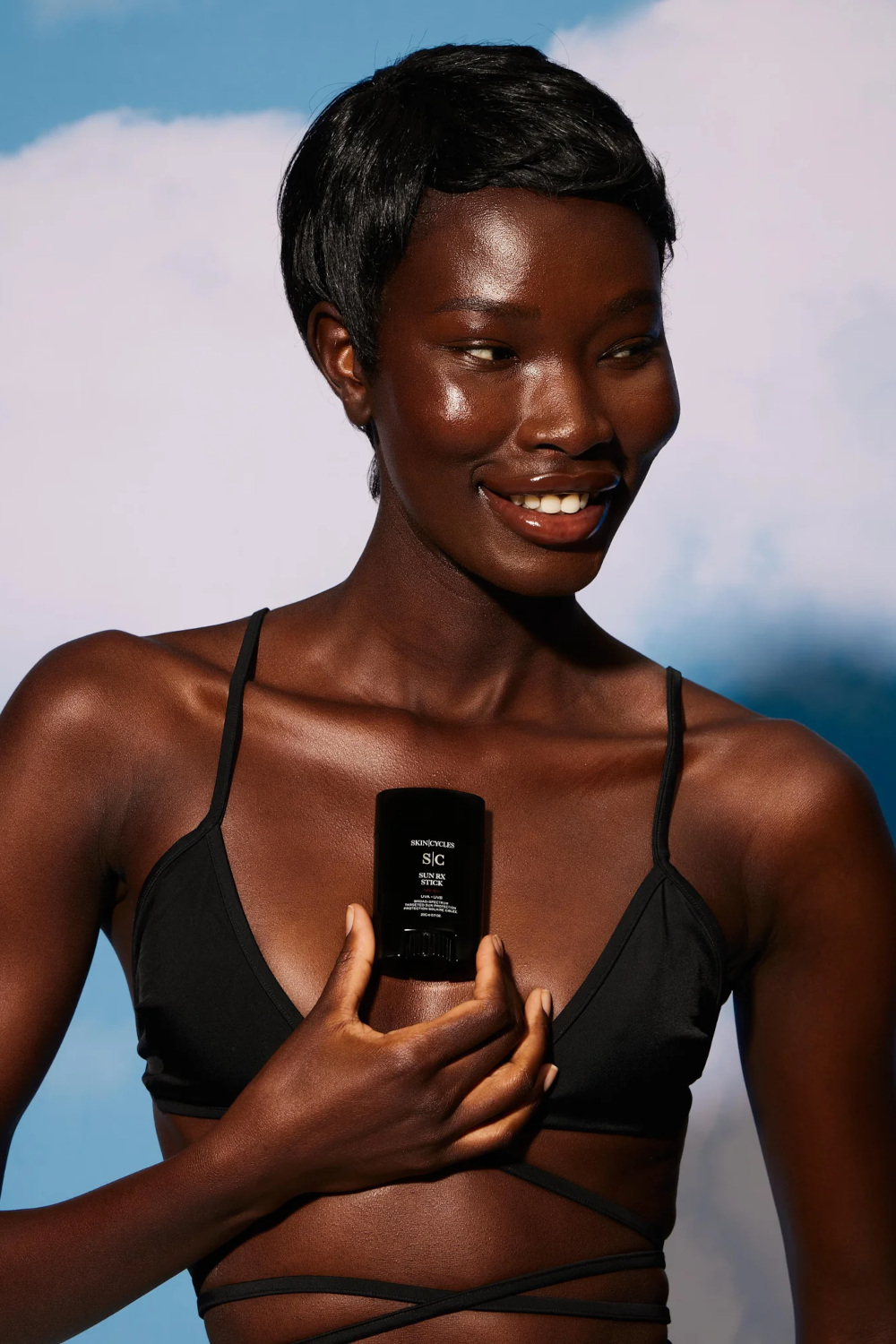 Woman holding SPF product