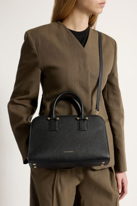 Woman wearing black handbag