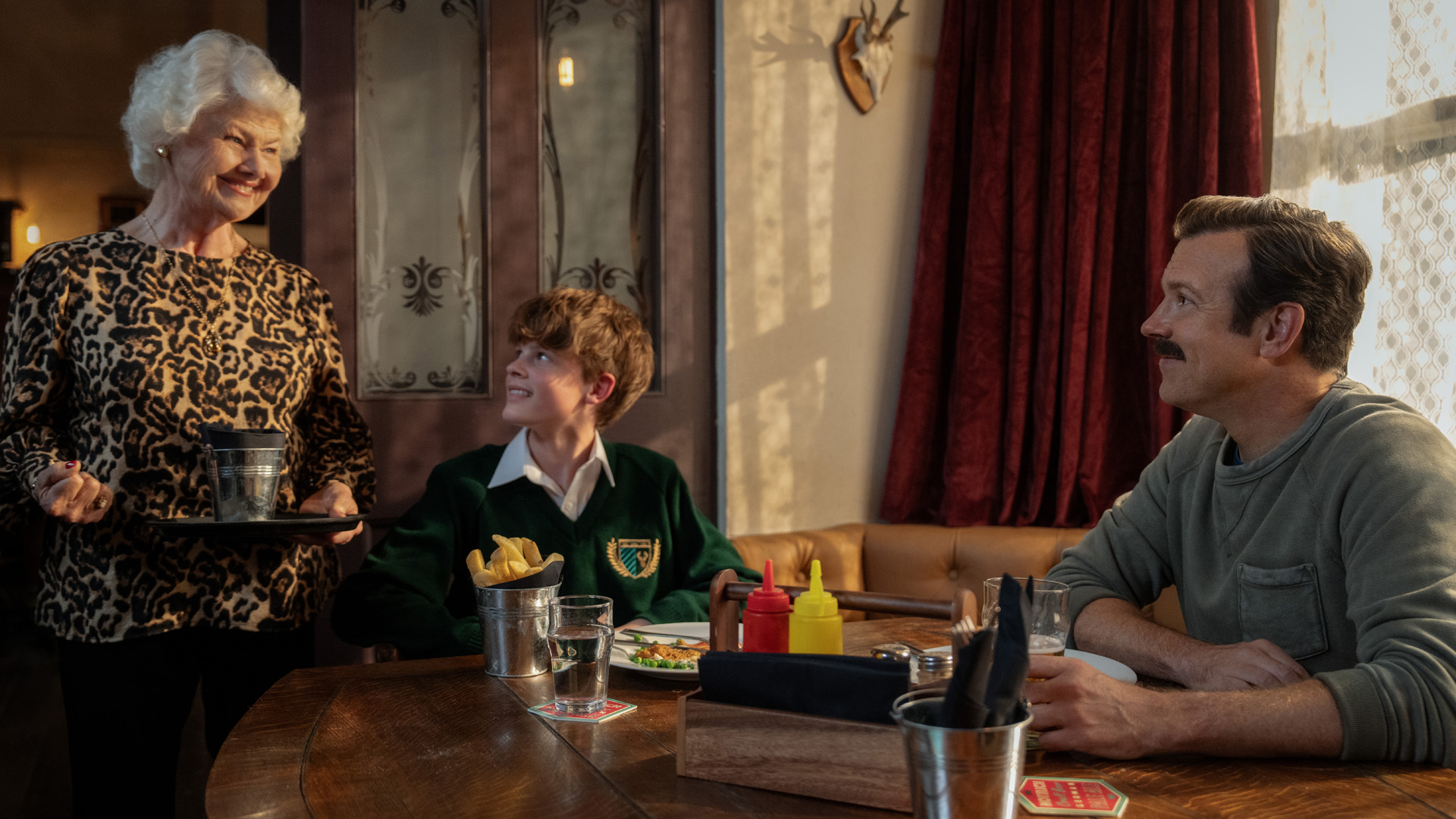 Annette Badland, Grant Feely and Jason Sudeikis in "Ted Lasso,"