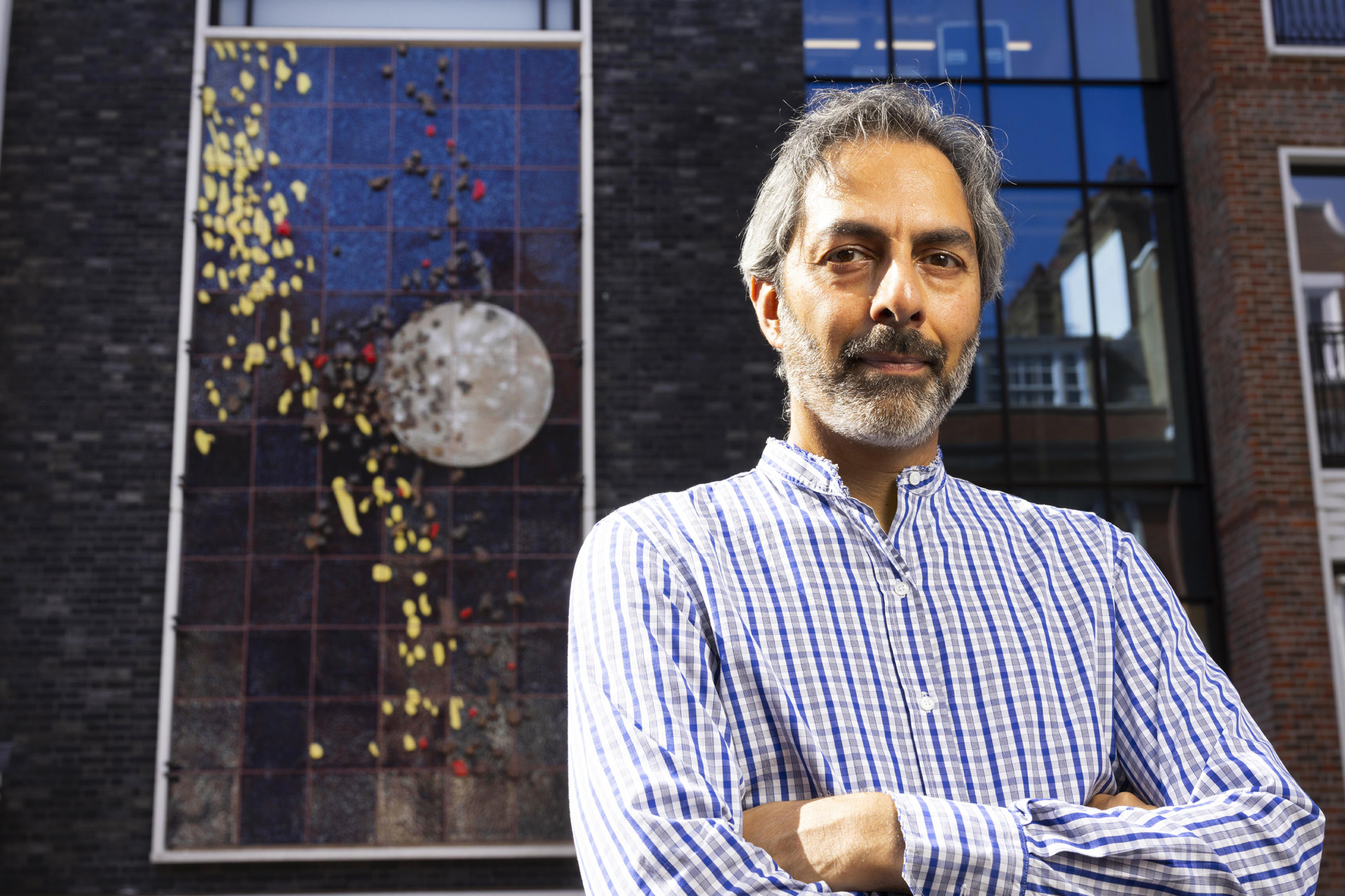 Shezad Dawood in front of his new artwork Cascade on the facade of The Gaumont
