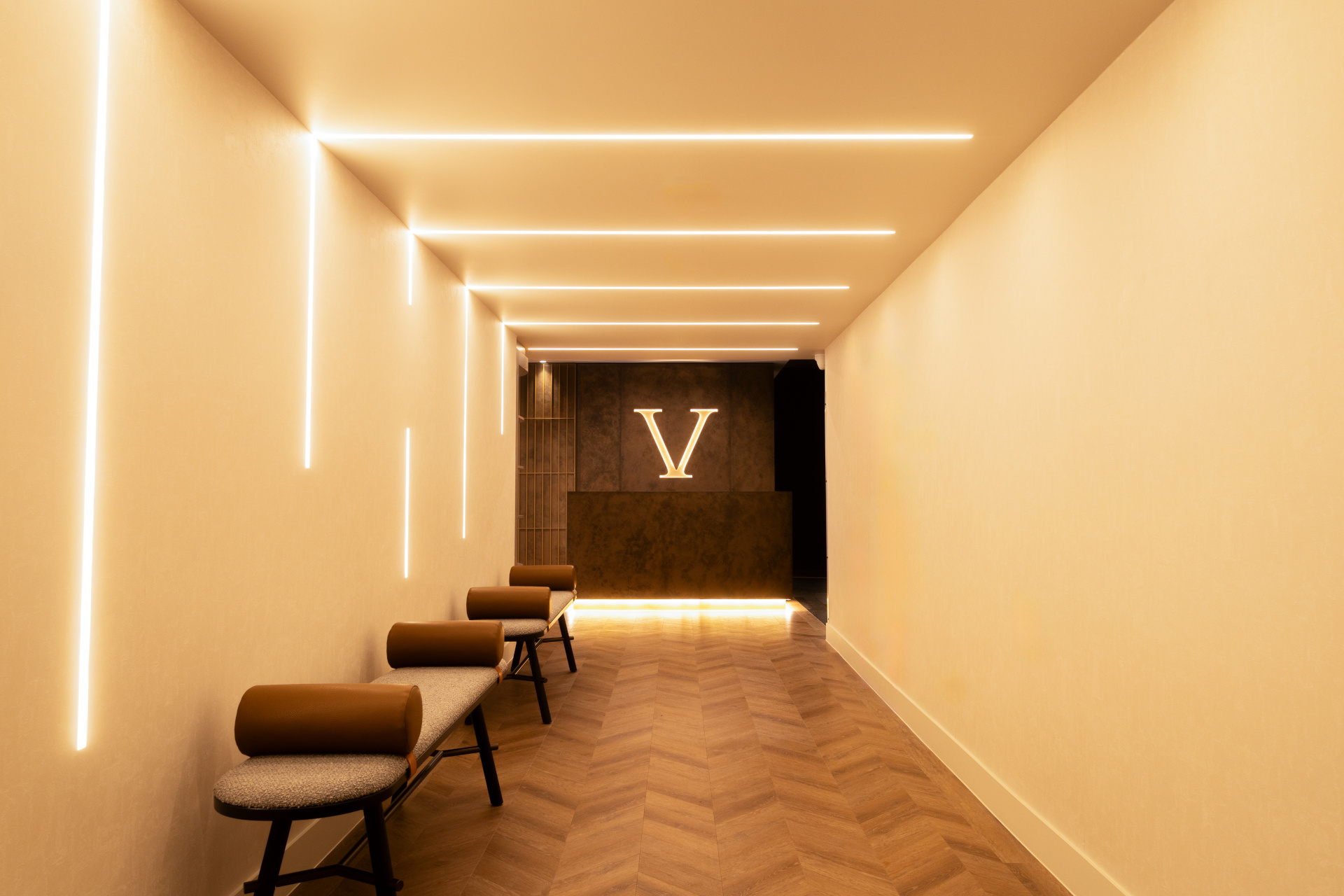 Gold-lit hallway leading to reception