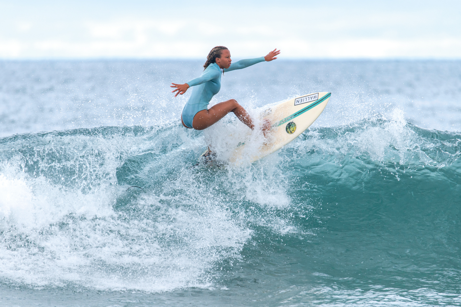 Woman surfing | swimwear alternatives