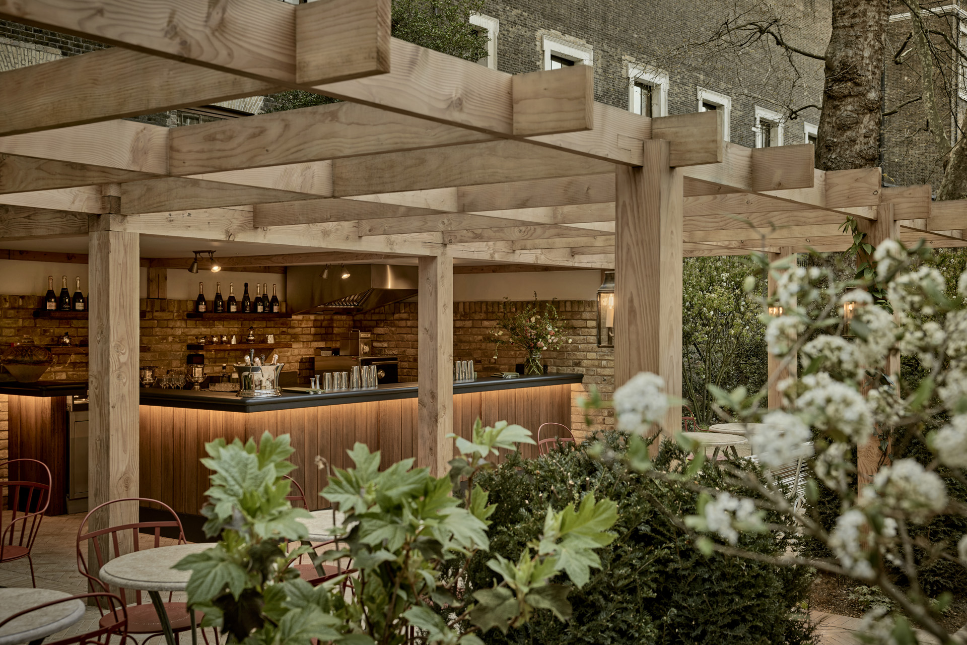 A bar along with tables and chairs in the garden at London hotel The Zetter Bloomsbury