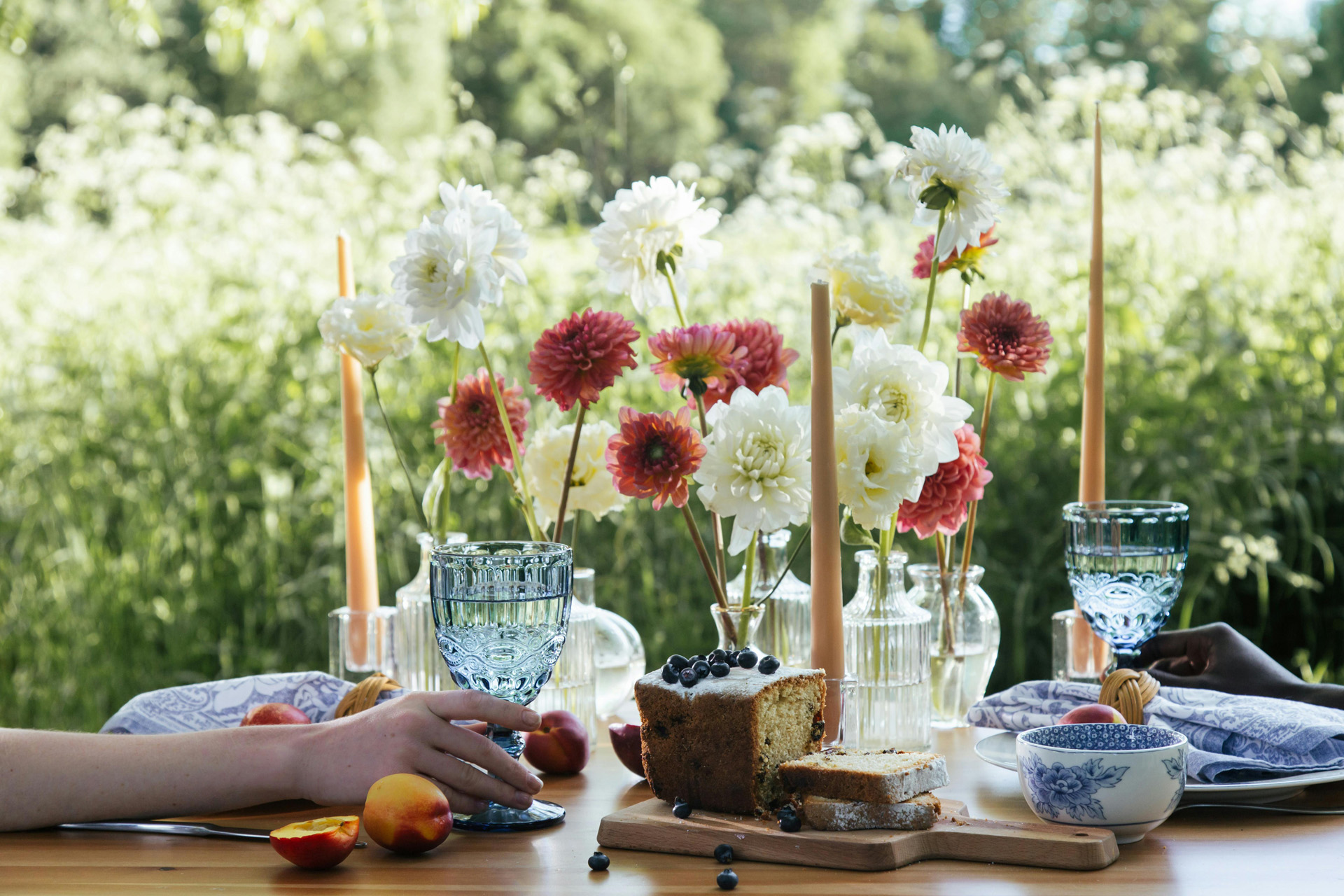An outdoor table with summer flowers