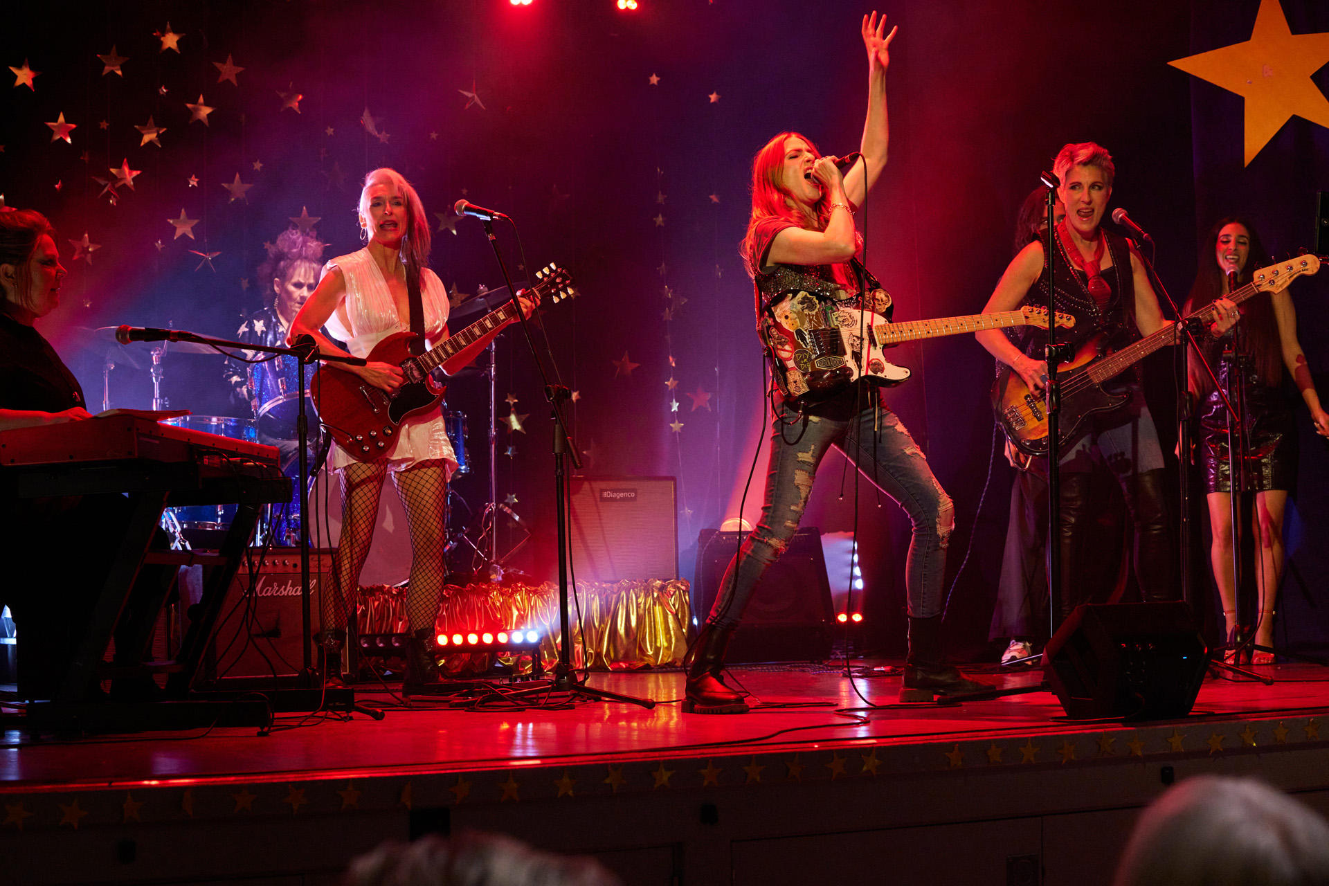 Beth Thornton (JOANNA SCANLAN), Jess Burchill (LORRAINE ASHBOURNE), Yvonne Vaux (AMELIA BULLMORE), Kitty Eckerson (ROSALIE CRAIG), Holly Gaskell (TAMSIN GREIG), Nisha Lal (TAJ ATWAL), & Kam Lal (CHANDEEP UPPAL) in Riot Women