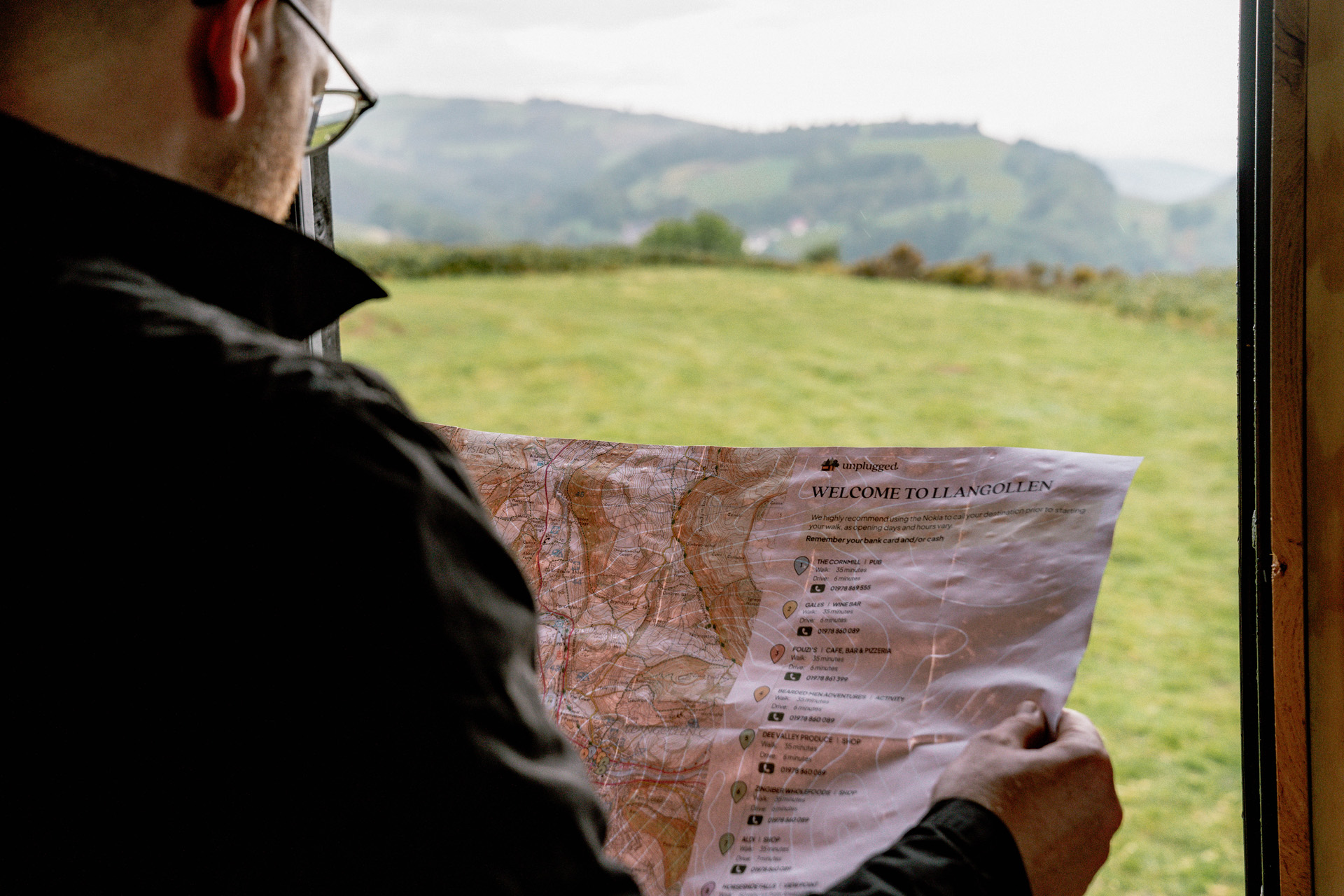A man looking at a paper map