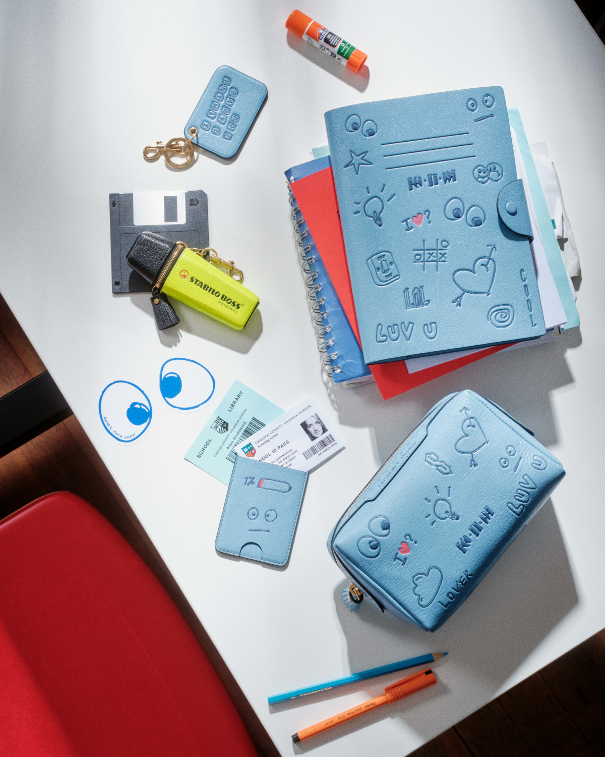 Desk with books, pencil cases, pens and highlighters