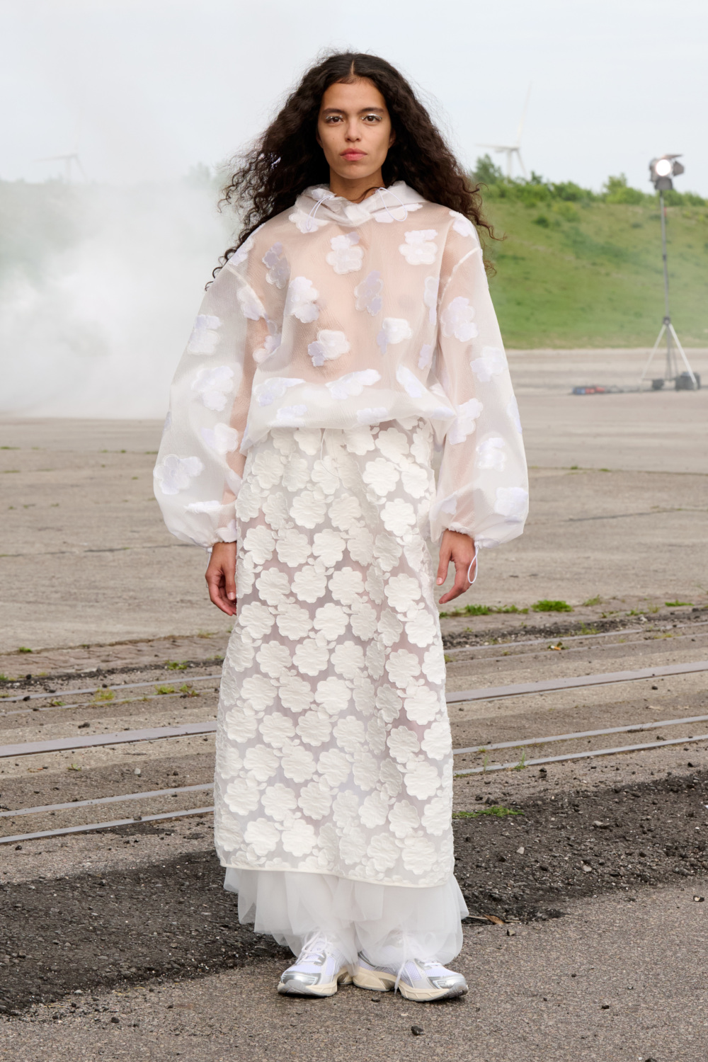 Model in white sheer floral outfit