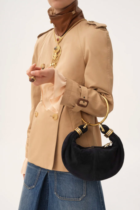 Woman holding black boho bag