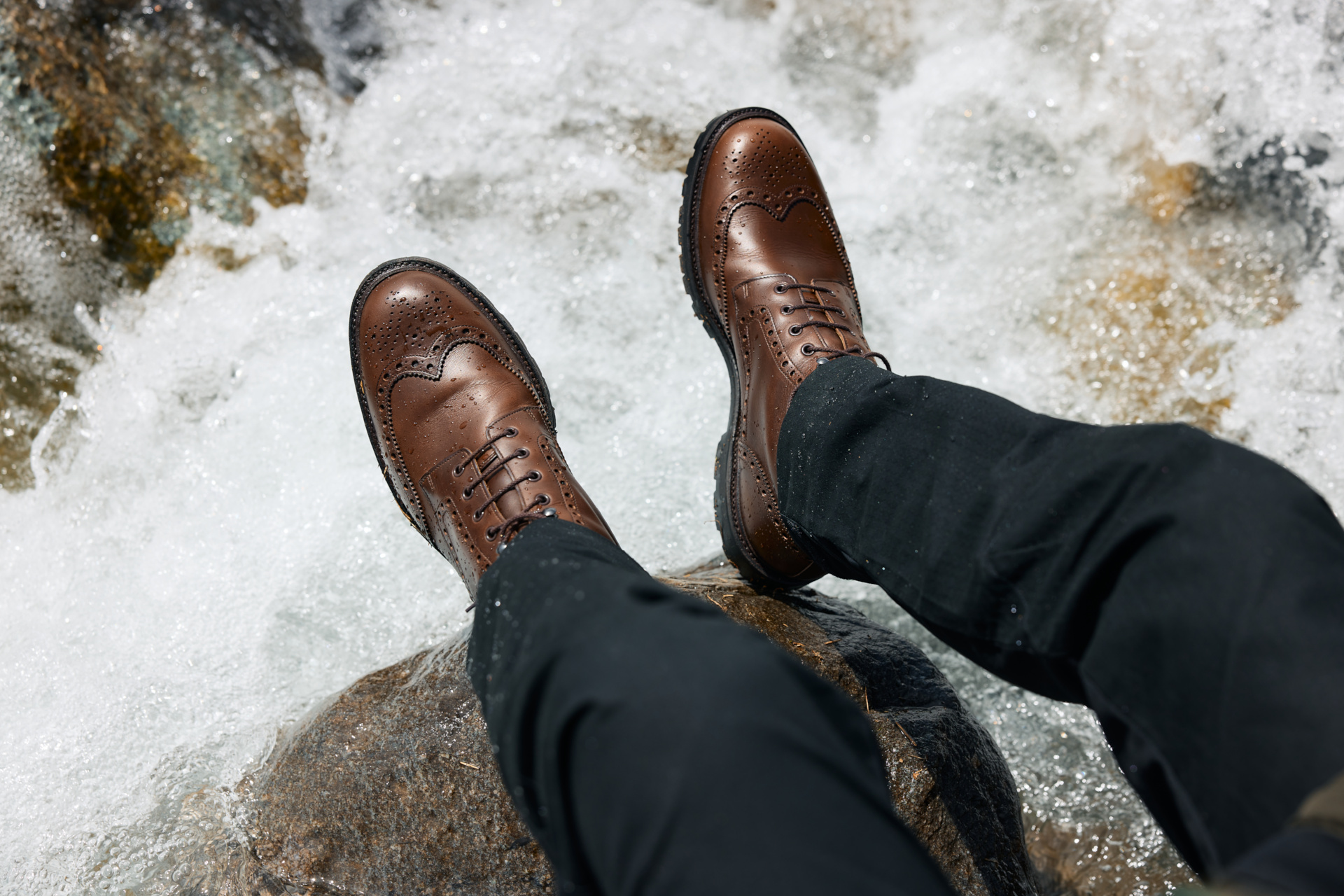 Feet hanging off icy rock
