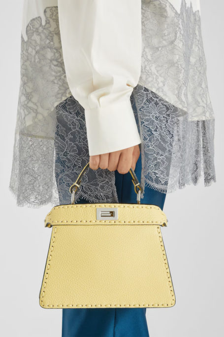 Woman holding yellow bag