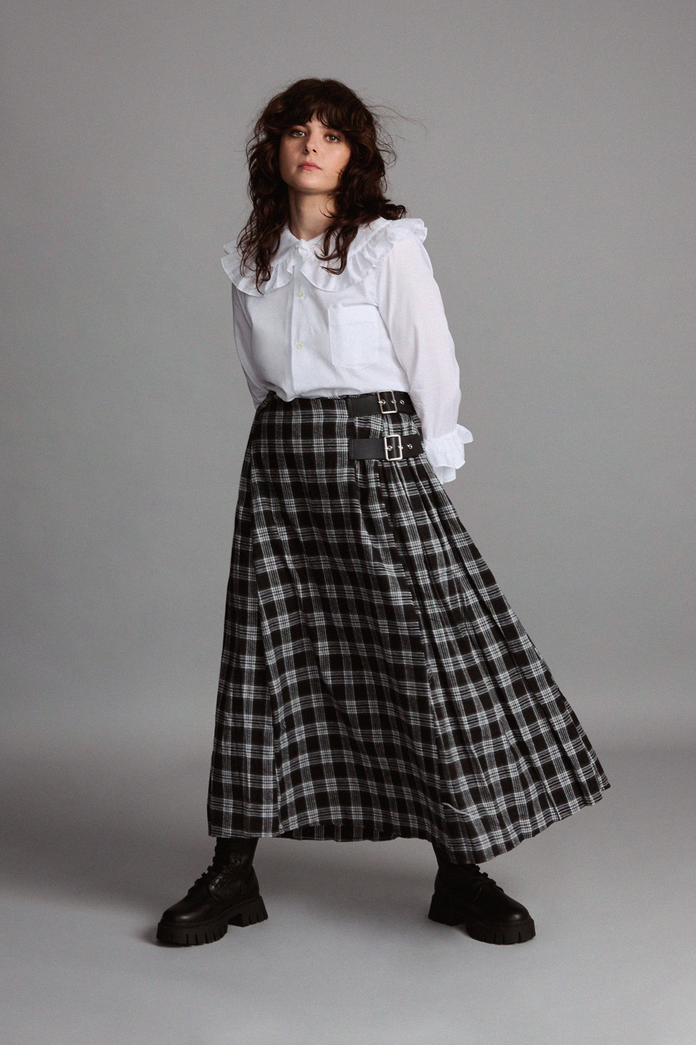 Gabrielle Creevy in a white blouse and a floor length tartan skirt