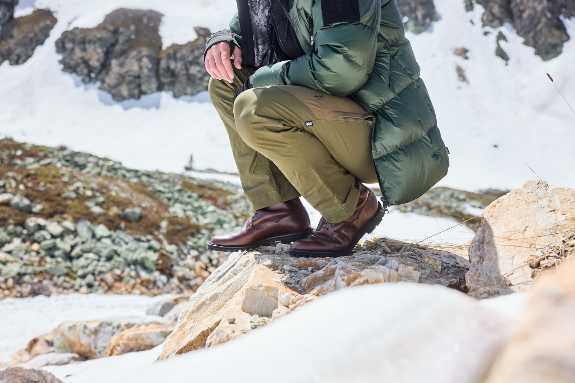 Man crouched wearing brown boots