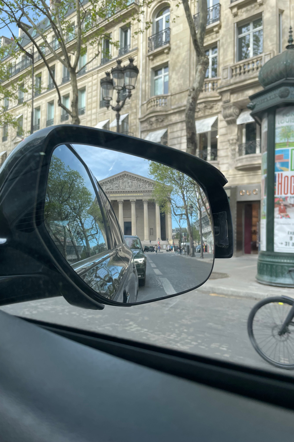 A monument reflected in a taxi wingmirror