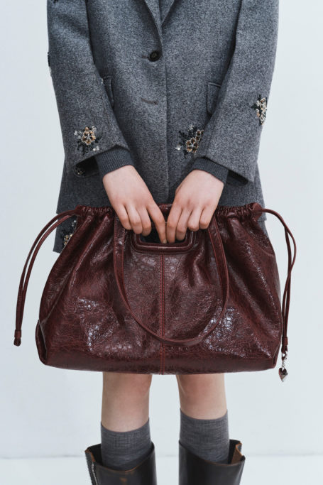 Woman holding brown bag