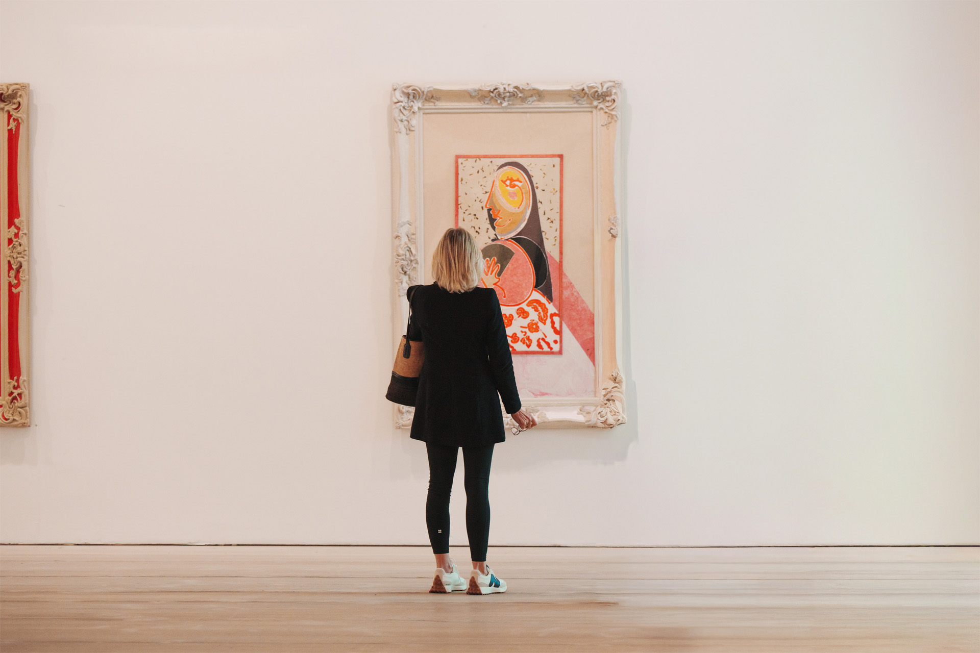 A woman looking at a painting