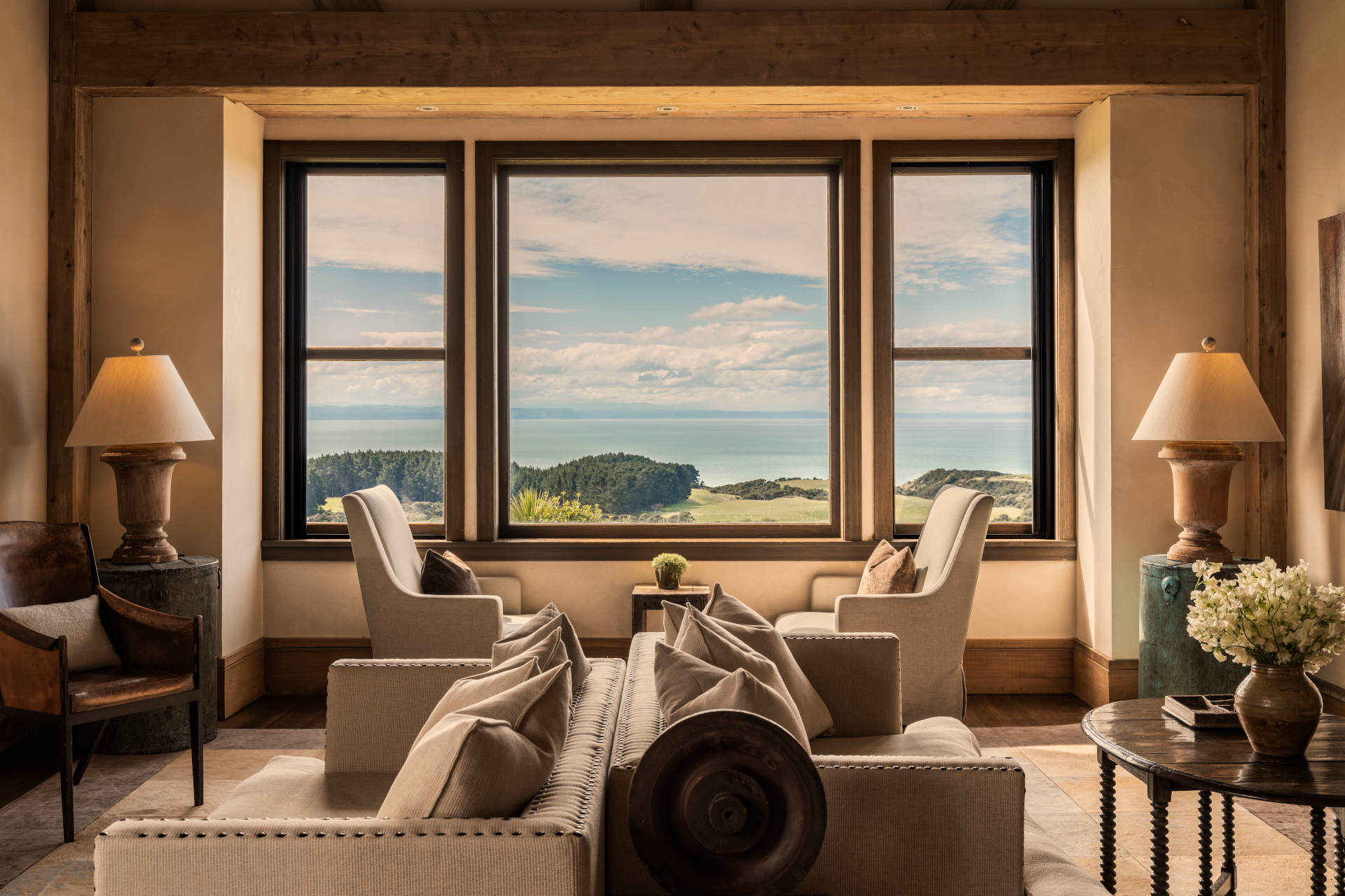 Sitting room with large windows looking out on rolling hills