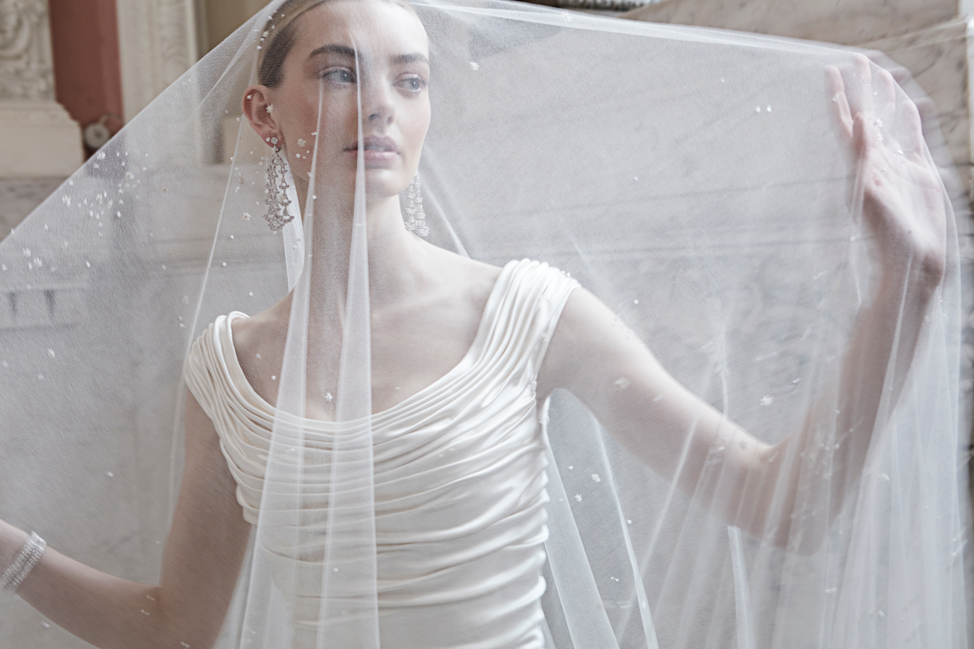 Model wearing wedding dress and veil