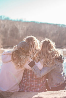 Three friends hugging