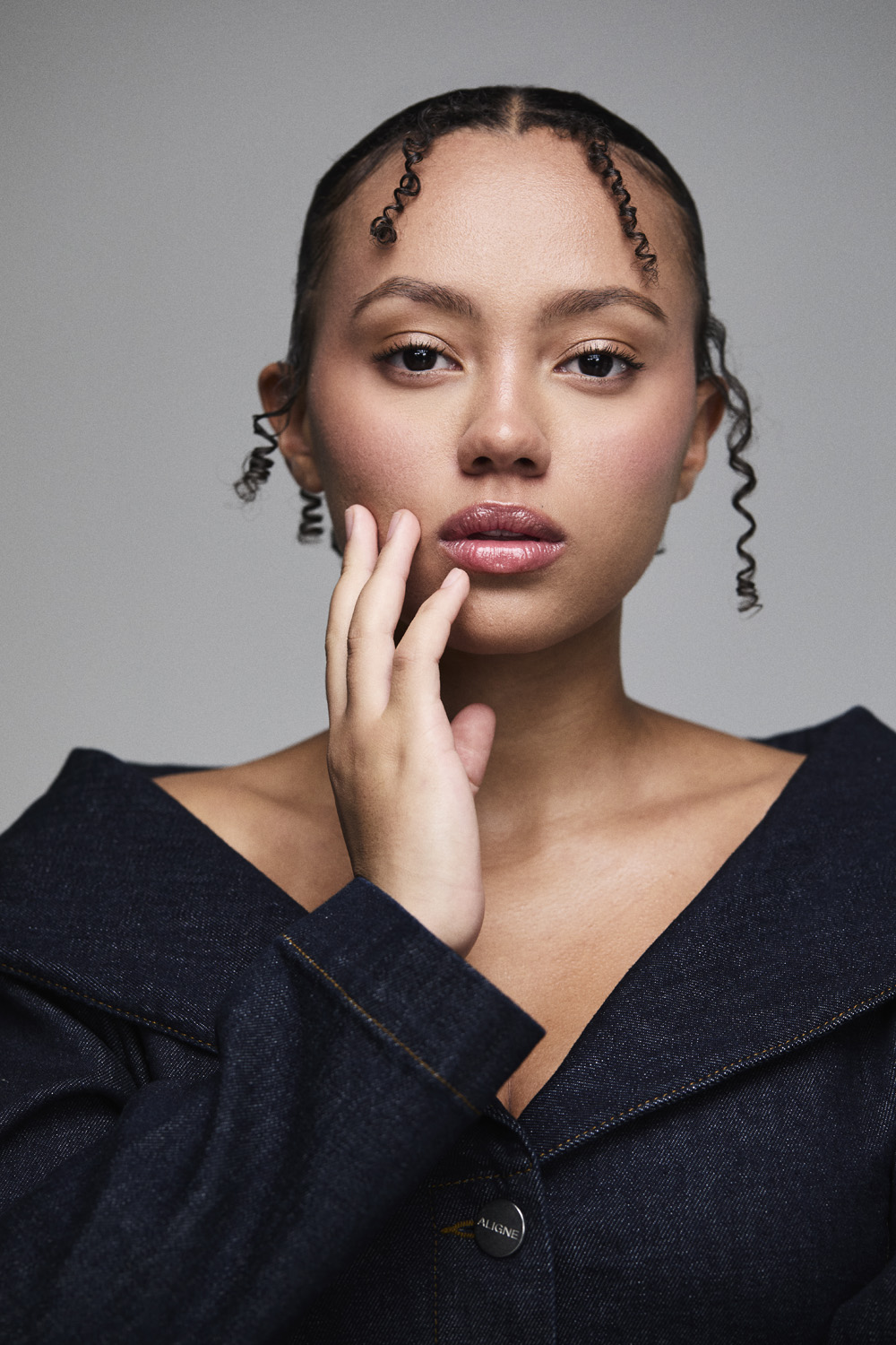 India Brown with her hand on her cheek