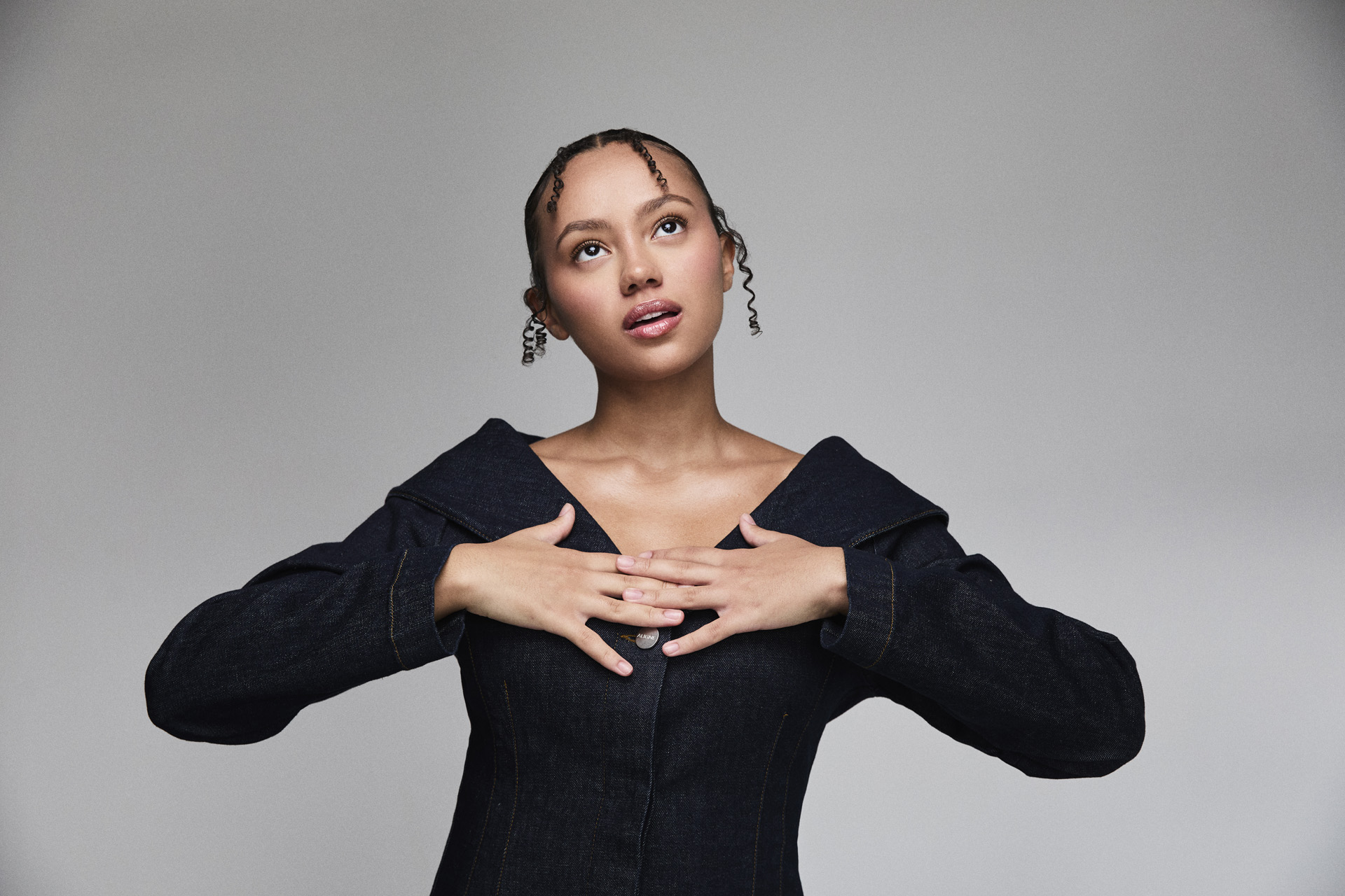 India Brown with her hands on her chest