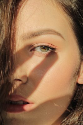 Woman with shadow of hand over face | Echelon Health brain MOT