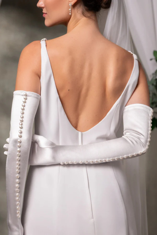 Woman wearing satin dress and gloves