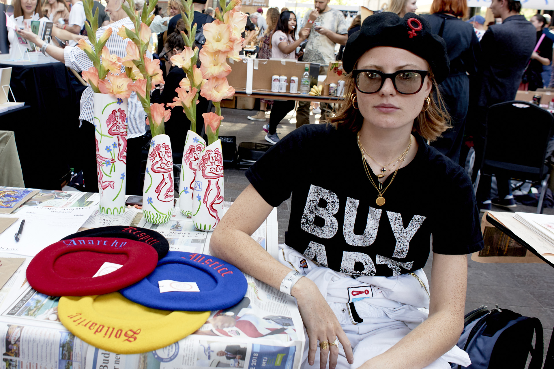 A woman selling hats at The Art Car Boot Fair
