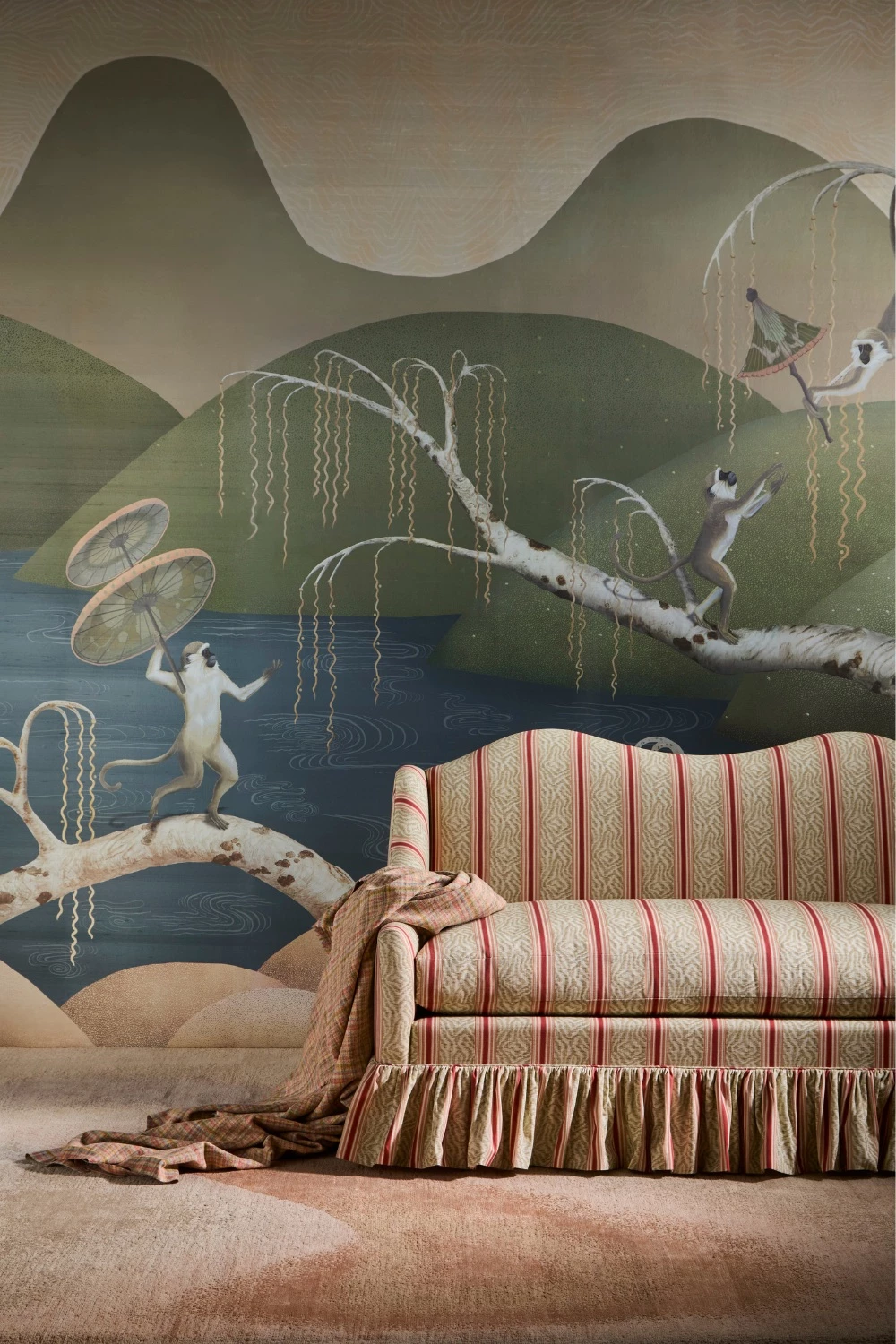 Mural wallpaper with monkeys, set behind striped sofa