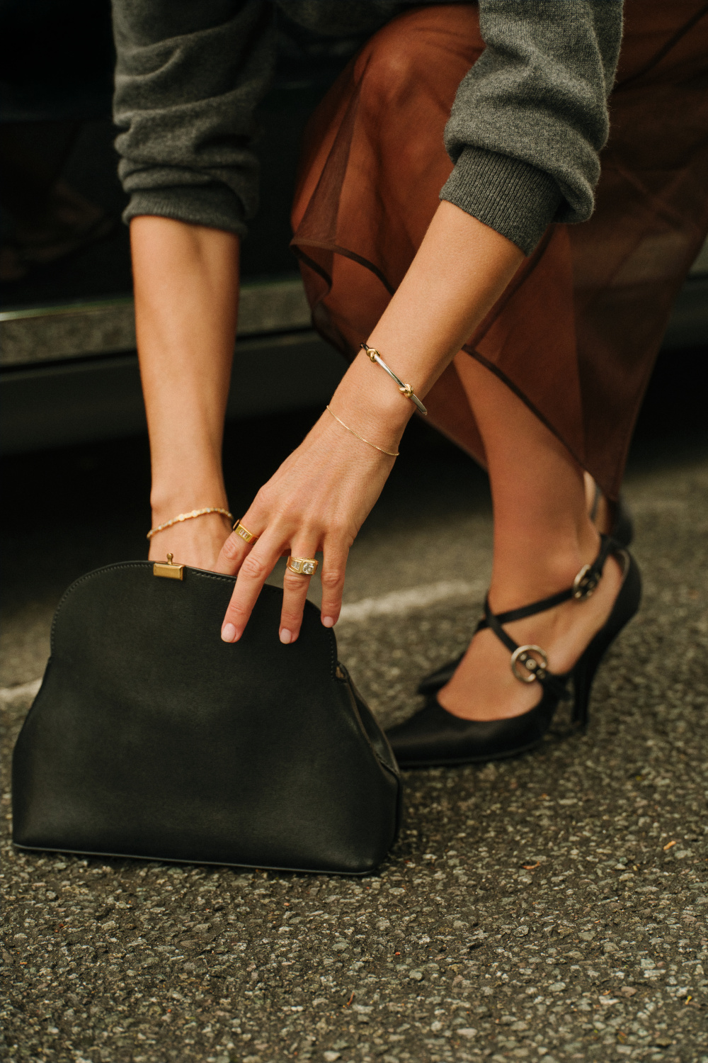Person bending down to look in their bag