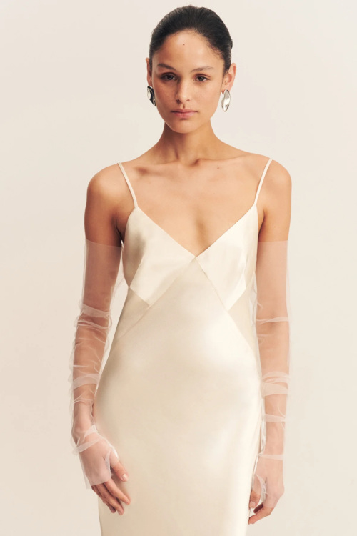 Woman in ivory slip and tulle gloves