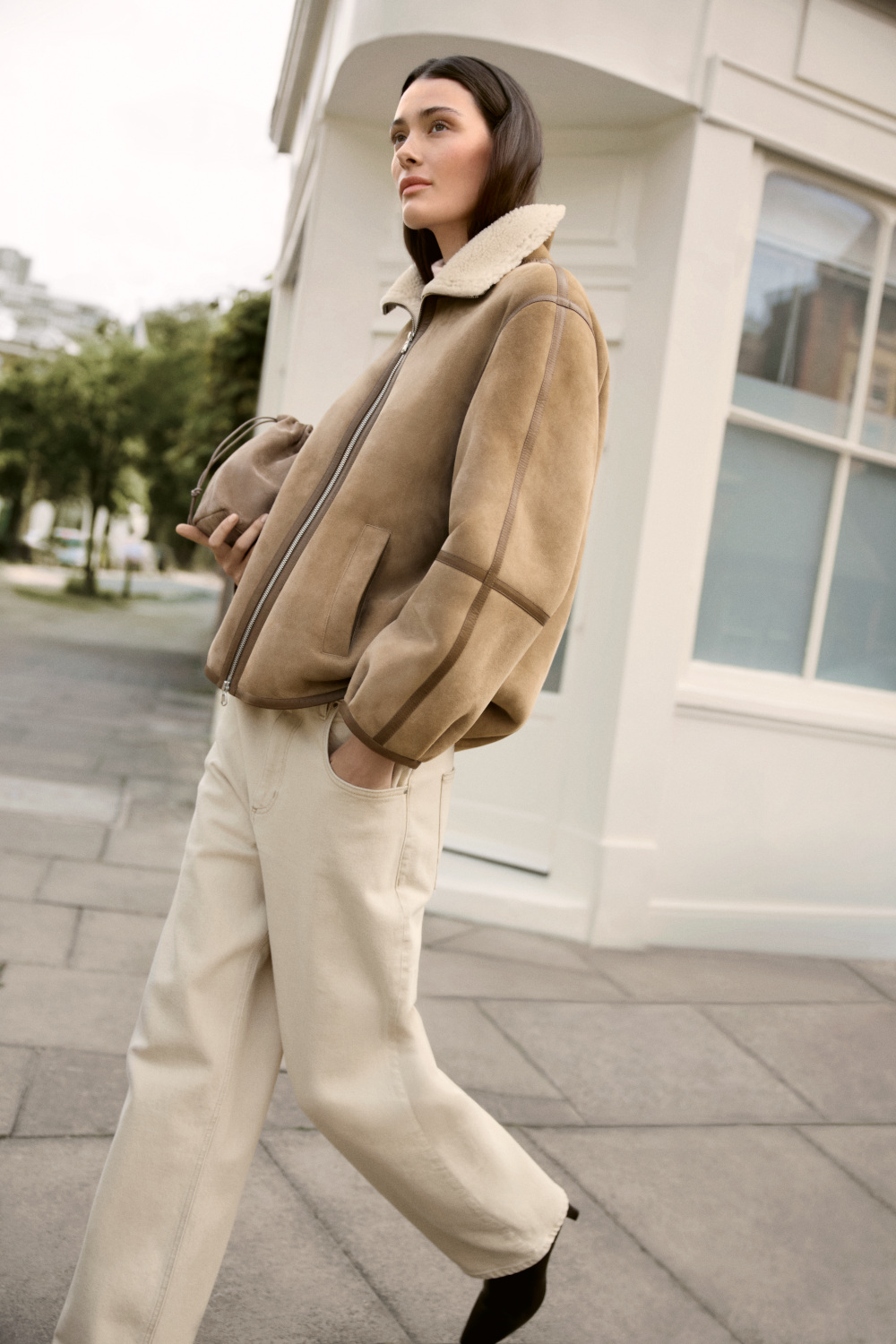 Woman in suede jacket from The White Company AW25 collection
