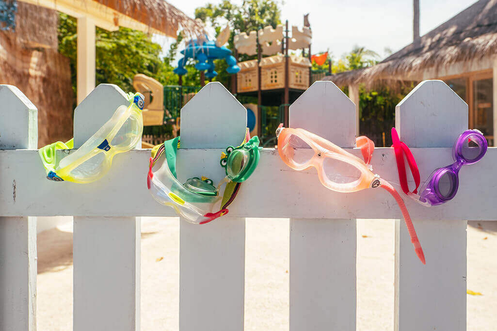 Goggles on a white picket fence