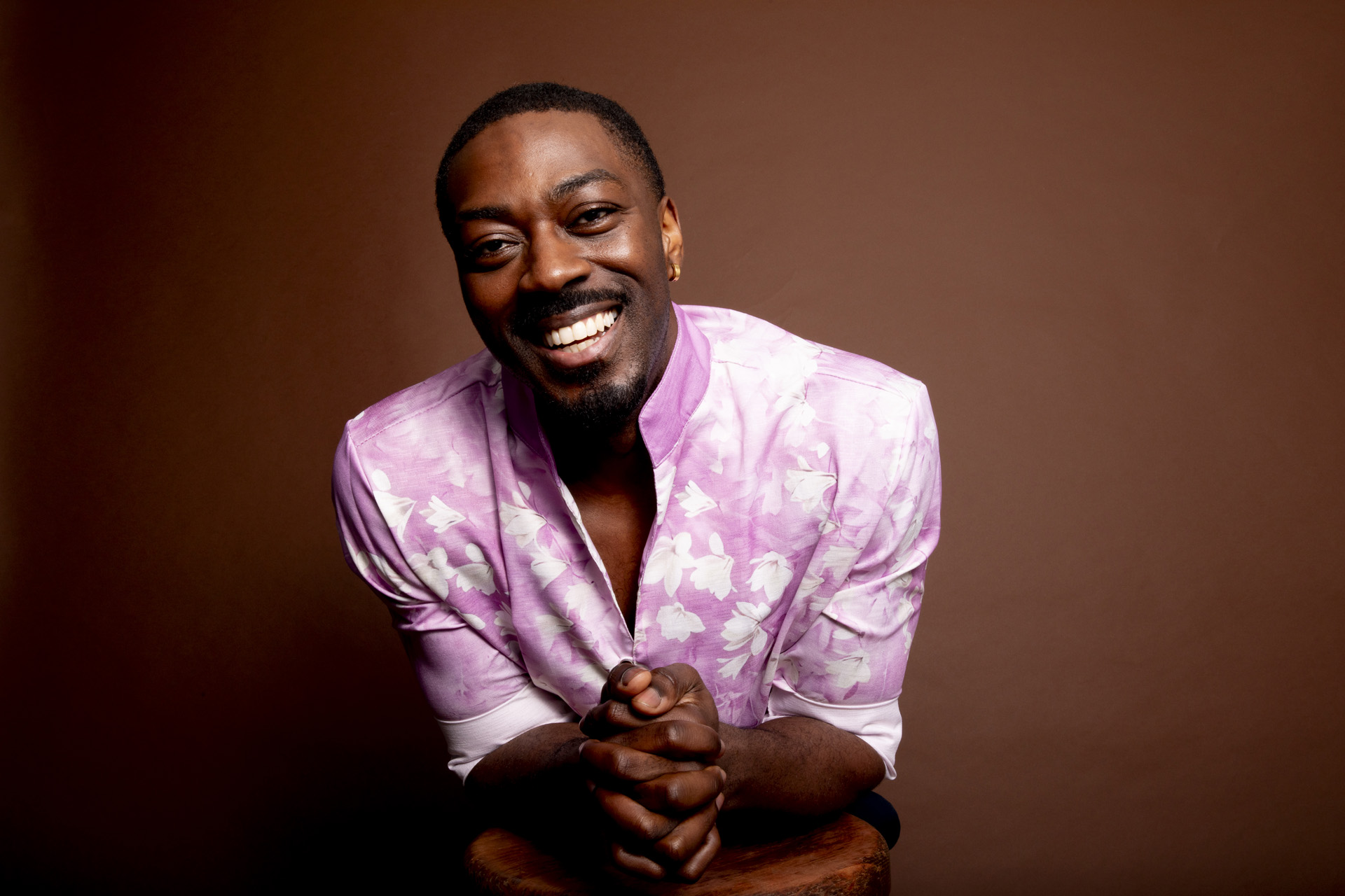 David Ajala in a pink shirt