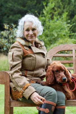 Philippa Gregory on a bench with her dog
